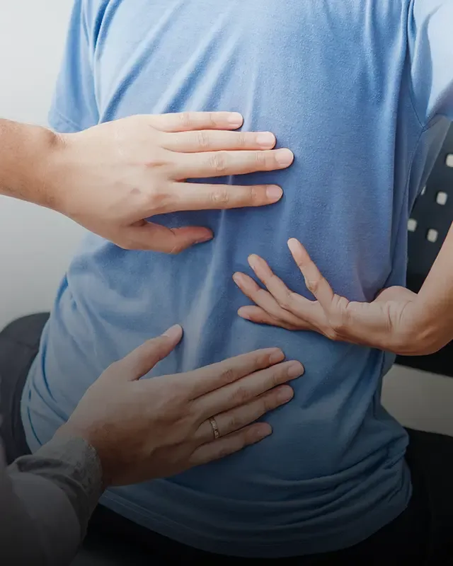 A chiropractor examining a patient's back